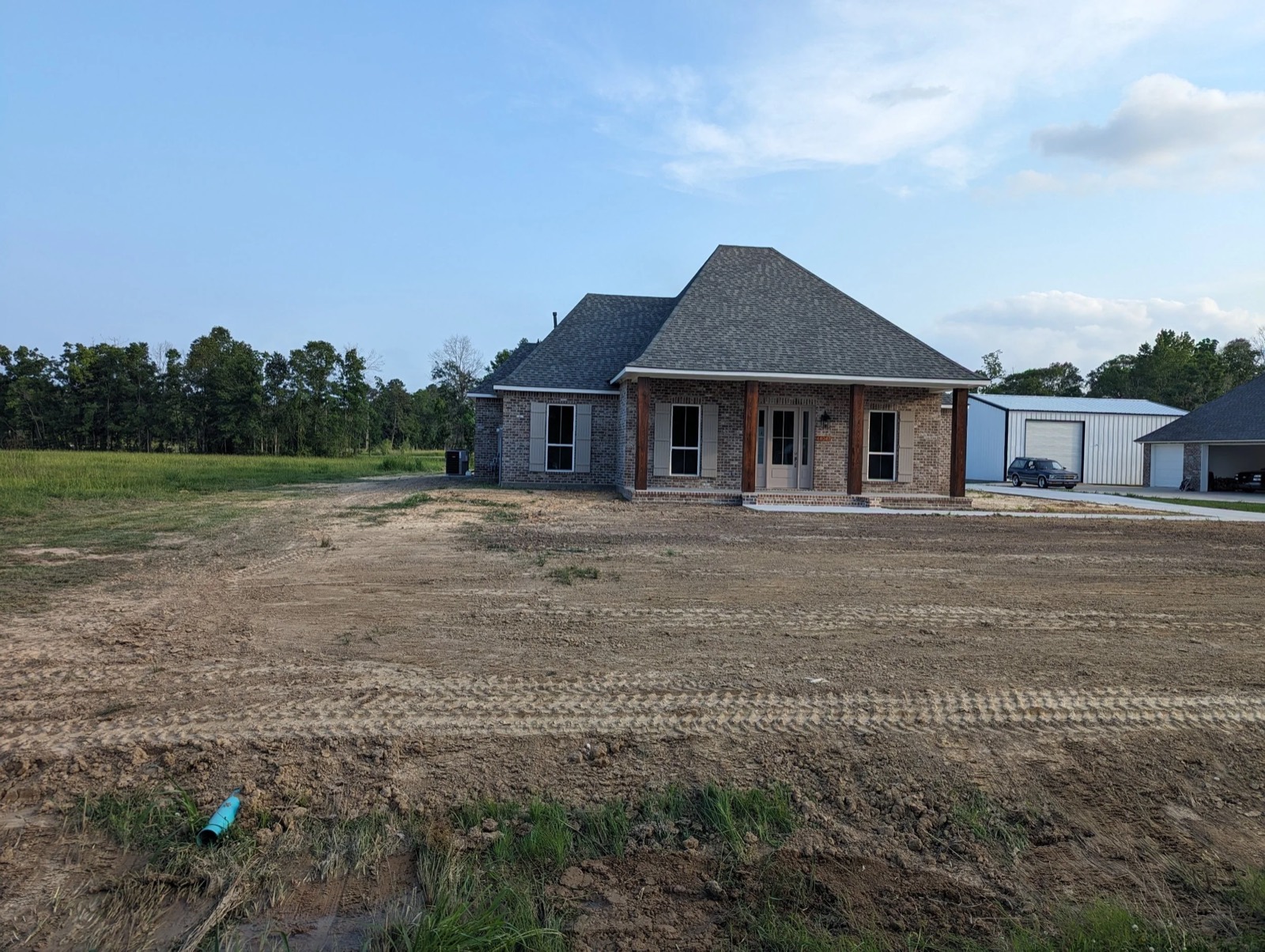 A newly built home on a freshly graded lot after site work.