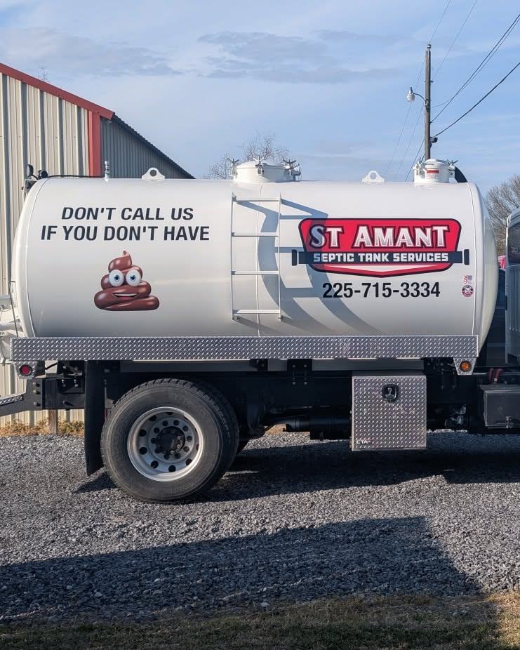 The St. Amant Septic pump truck, lettered with the company name and phone number.