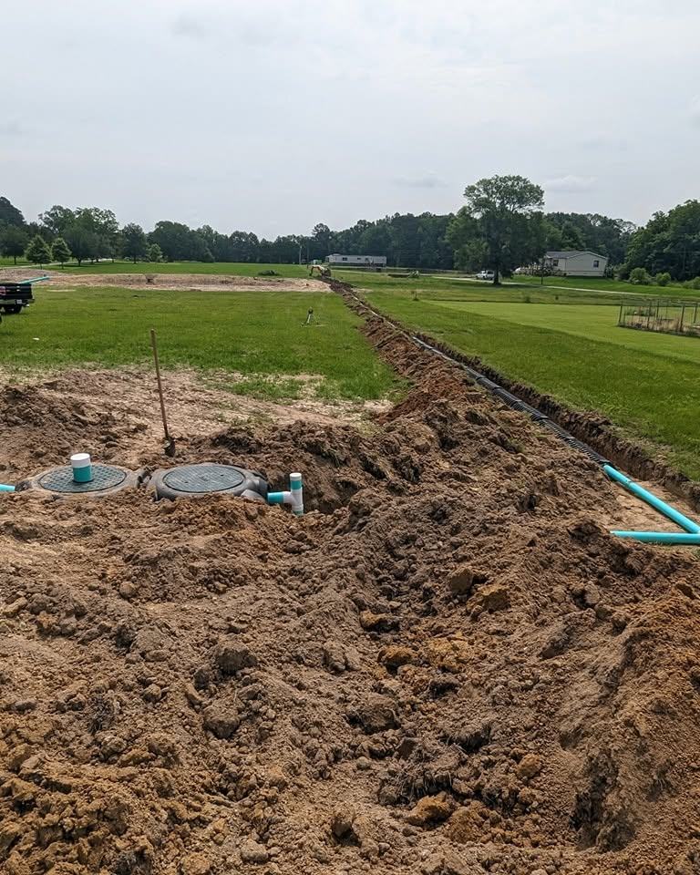 Tank access lids set and the trench run back across the field.