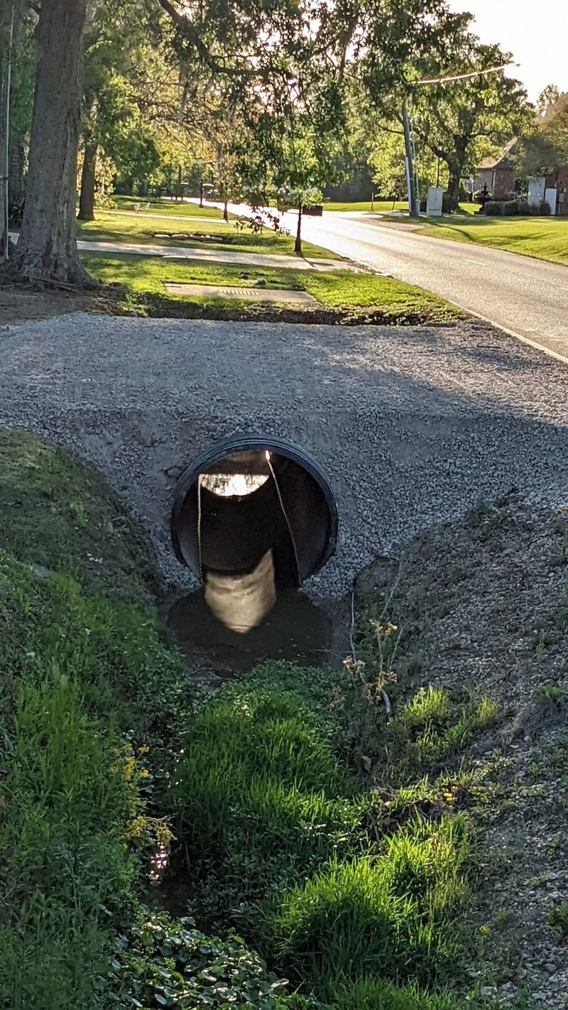 A culvert set under a new gravel driveway.