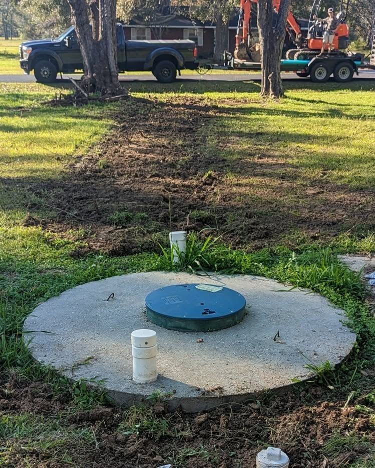 A concrete cover slab and green access lid finished off in a lawn.