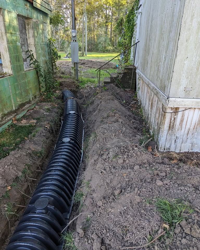 A corrugated drain line laid in alongside a mobile home.