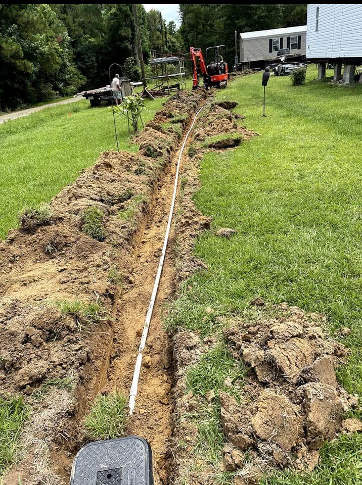 A service trench run across the lawn to a mobile home.