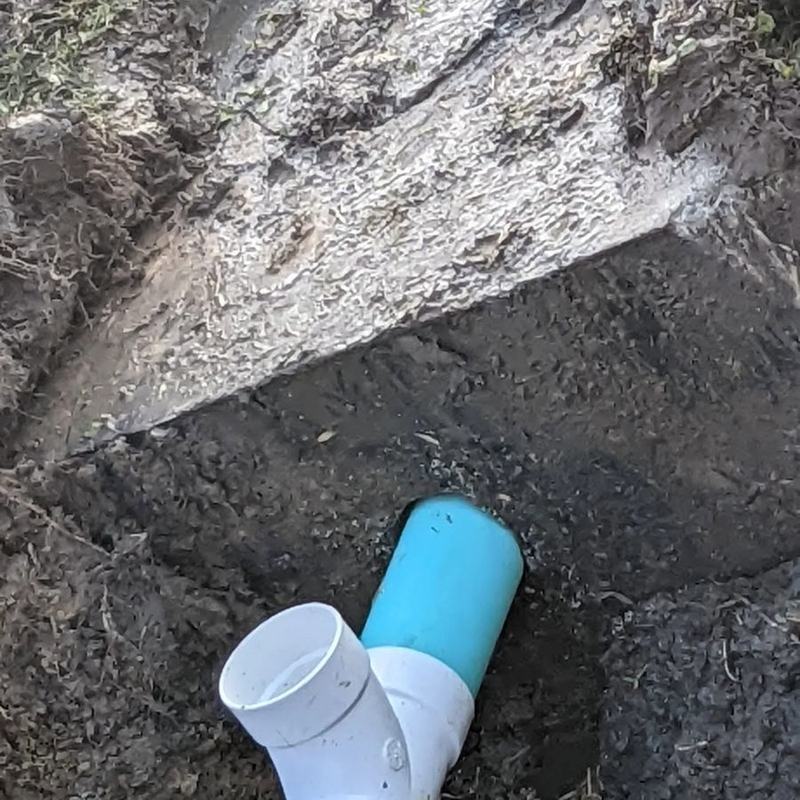 Cut pipe ends in an open trench during a line repair.